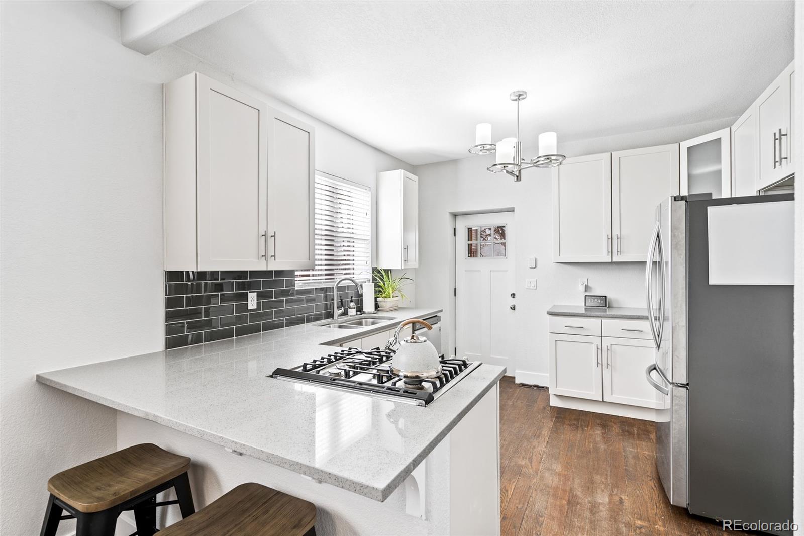 Undisclosed Address Denver, CO 80216 - Photo 9 of 25 a kitchen with white cabinets and appliances