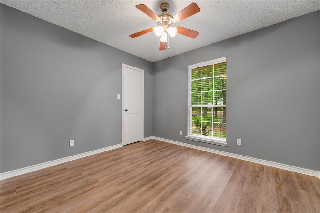 248 Butternut Lane Powderly, TX 75473 - Photo 29 of 40 wooden floor in an empty room with a window