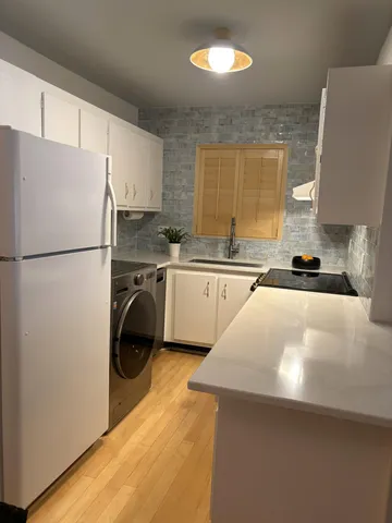 a kitchen with a sink a refrigerator and a stove