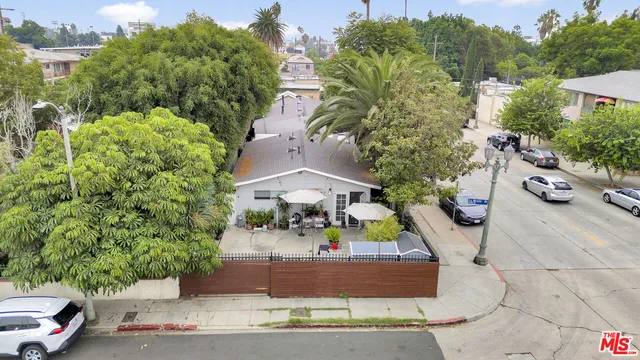 an aerial view of a house with a garden and trees