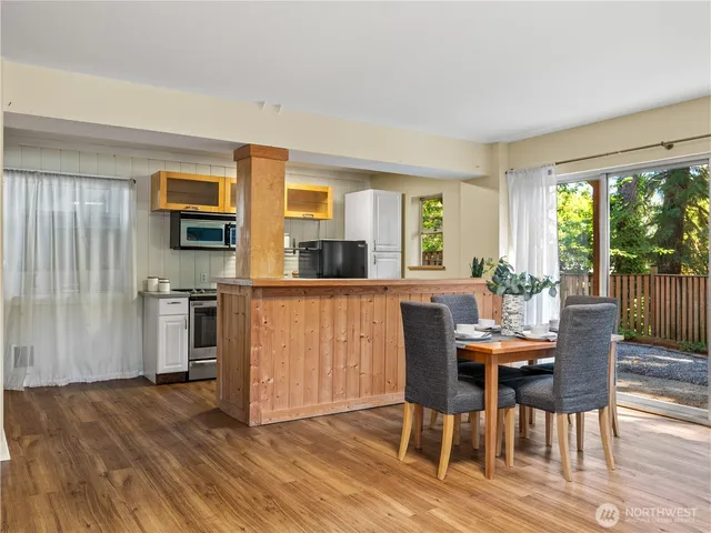 a view of a dining room with furniture window and wooden floor