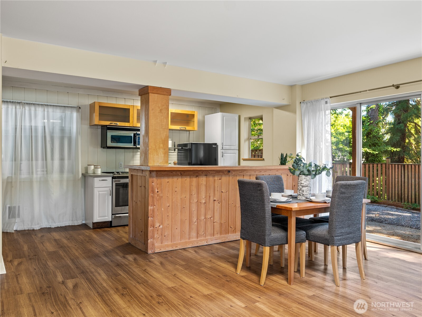 465 Winslow Way East, Unit 108 Bainbridge Island, WA 98110 - Photo 11 of 38 a view of a dining room with furniture window and wooden floor