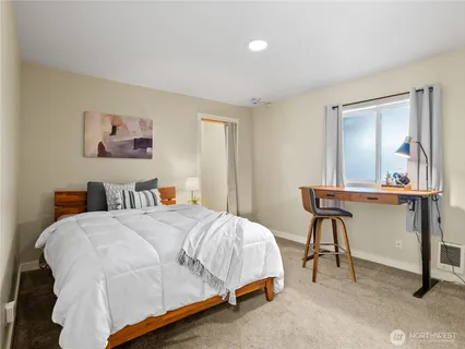 a bedroom with a bed and a table