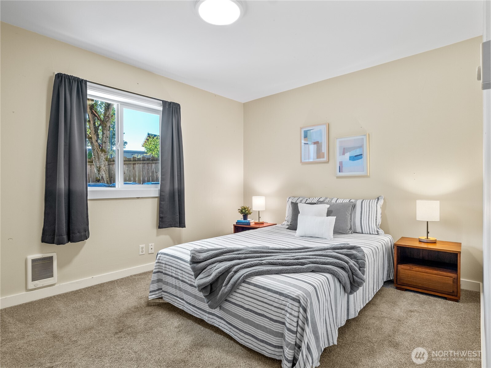 465 Winslow Way East, Unit 108 Bainbridge Island, WA 98110 - Photo 19 of 38 a bedroom with a bed and glass window