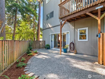 a view of a house with wooden fence next to a road