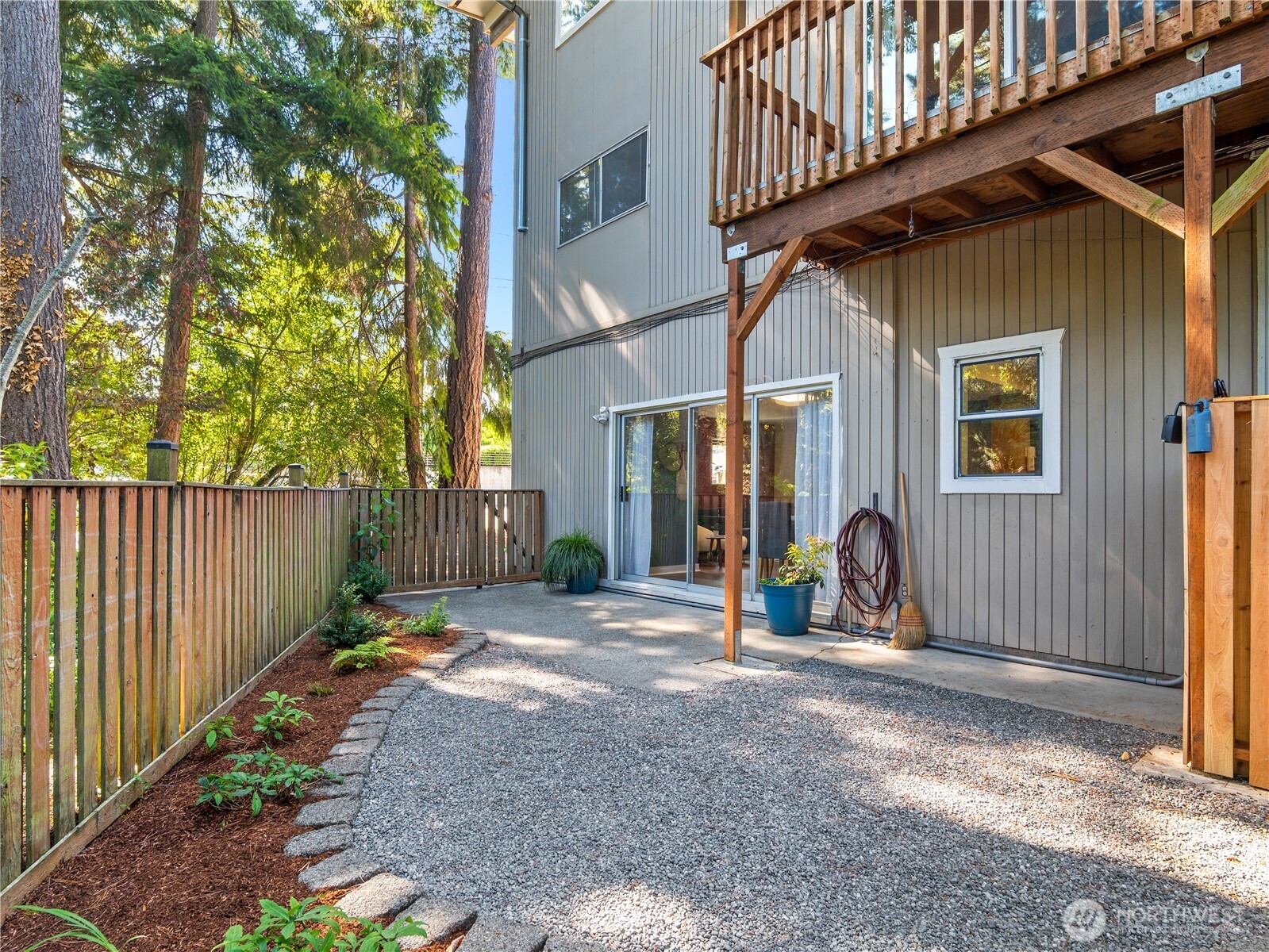 465 Winslow Way East, Unit 108 Bainbridge Island, WA 98110 - Photo 2 of 38 a view of a house with wooden fence next to a road