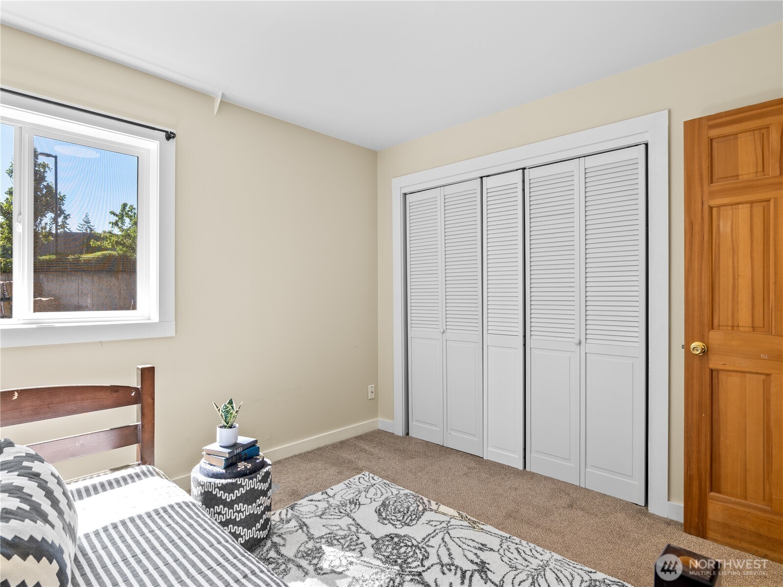 465 Winslow Way East, Unit 108 Bainbridge Island, WA 98110 - Photo 22 of 38 a bedroom with a bed and wooden floor