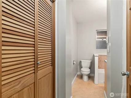 a bathroom with a toilet and a shower