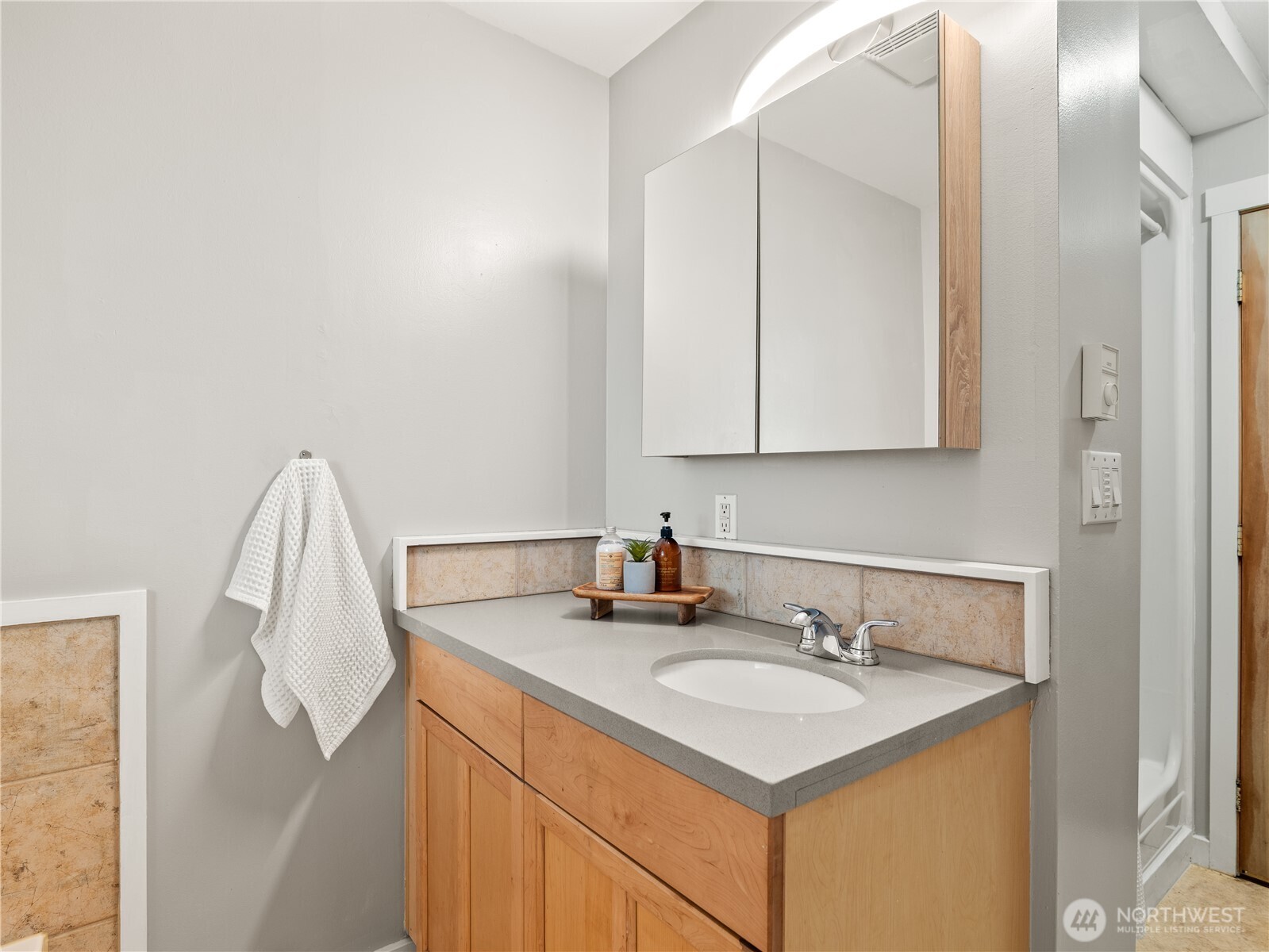 465 Winslow Way East, Unit 108 Bainbridge Island, WA 98110 - Photo 24 of 38 a bathroom with a sink and a mirror