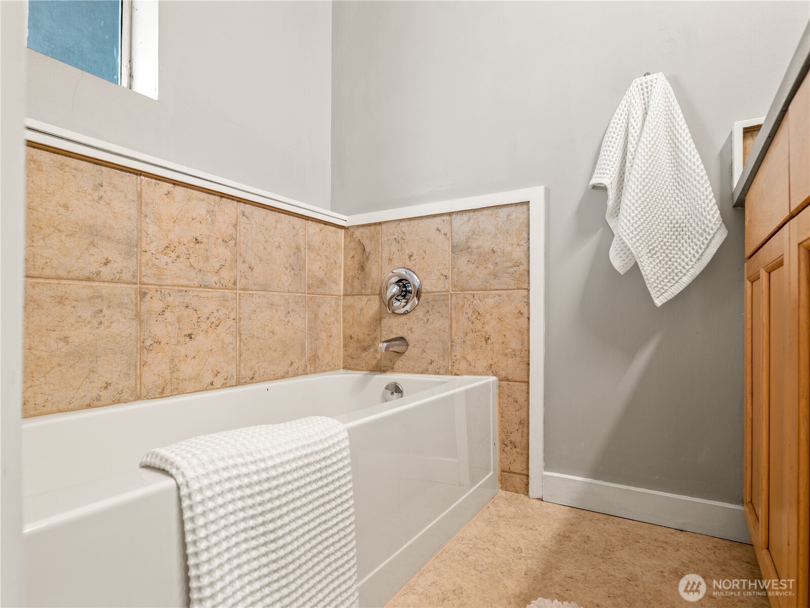 465 Winslow Way East, Unit 108 Bainbridge Island, WA 98110 - Photo 25 of 38 a white bath tub sitting next to a white sink and vanity