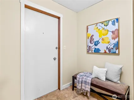 a bedroom with a bed and a painting on the wall