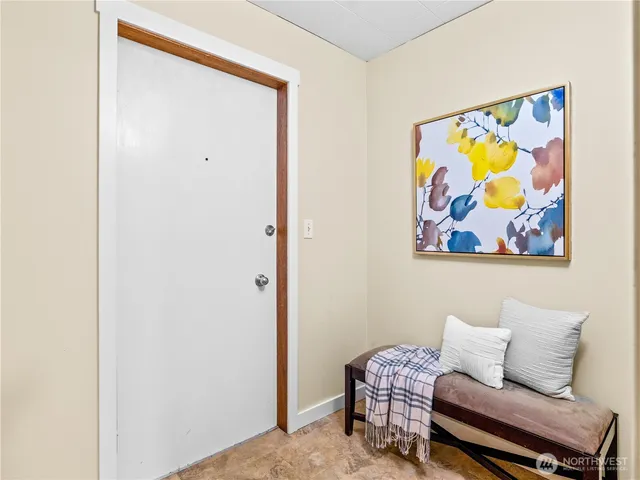 a bedroom with a bed and a painting on the wall