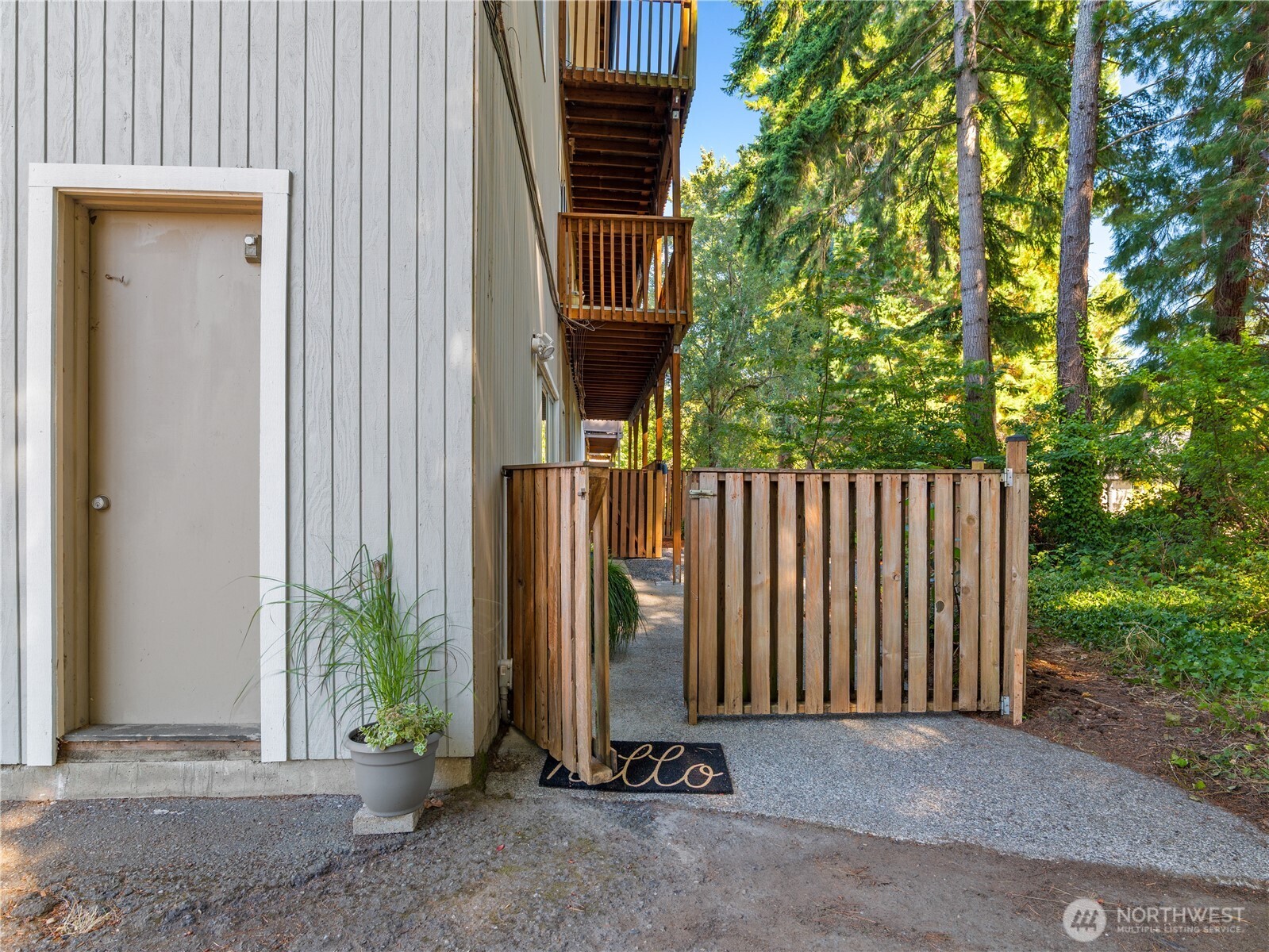 465 Winslow Way East, Unit 108 Bainbridge Island, WA 98110 - Photo 29 of 38 a view of a house with a small yard and a large tree