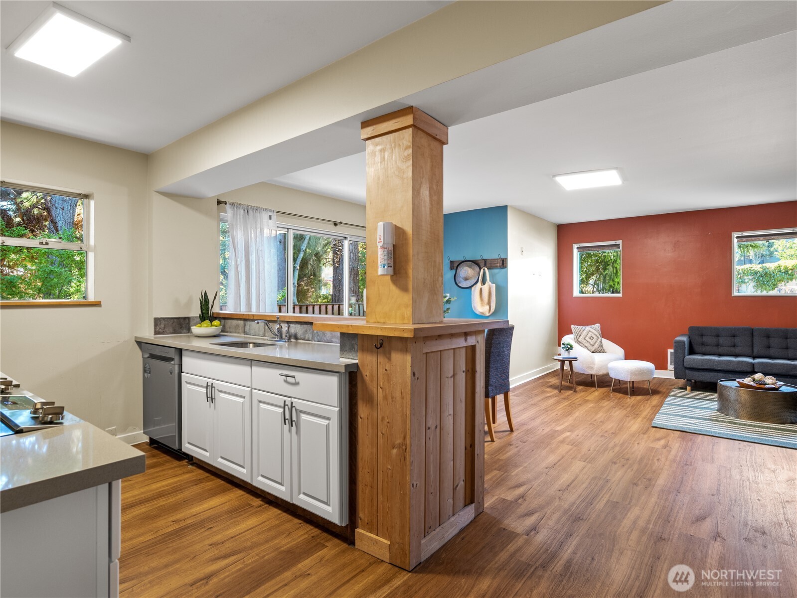 465 Winslow Way East, Unit 108 Bainbridge Island, WA 98110 - Photo 6 of 38 a view of a kitchen counter top space with furniture and wooden floor
