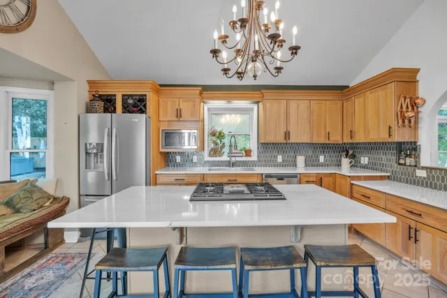 a kitchen with a table chairs stove and refrigerator