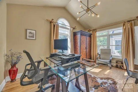 a living room with furniture and a floor to ceiling window