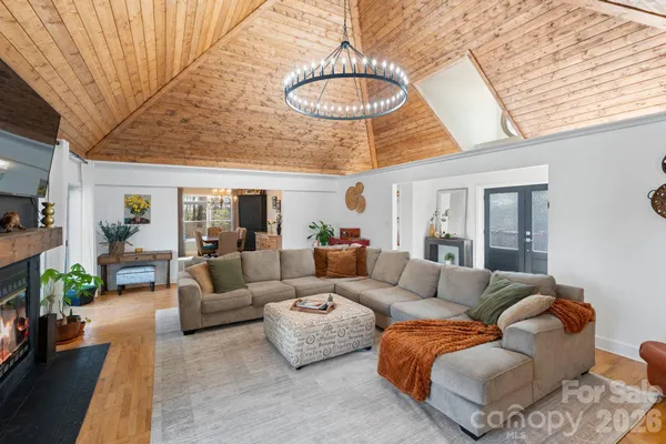 a living room with furniture and a chandelier