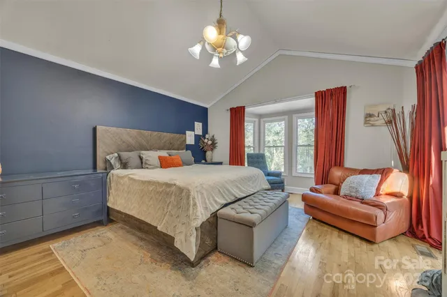 a bedroom with a large bed and a large window