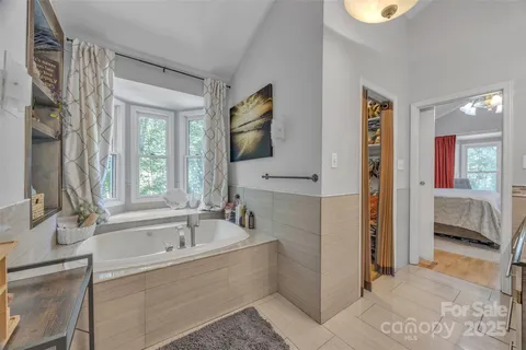 a spacious bathroom with a granite countertop toilet a sink and a mirror