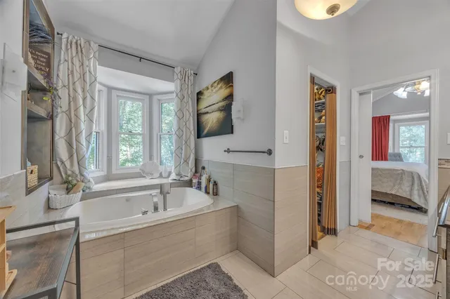 a spacious bathroom with a granite countertop toilet a sink and a mirror