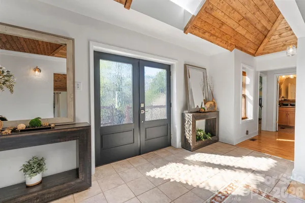 a kitchen with a stove a clock chandelier and a table