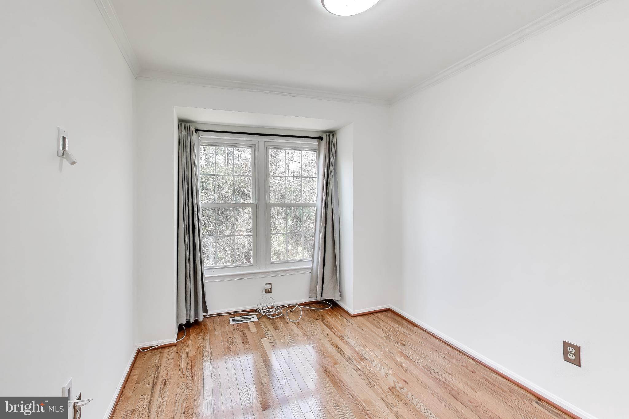 20210 Maple Leaf Court Gaithersburg, MD 20886 - Photo 11 of 31 an empty room with wooden floor and windows
