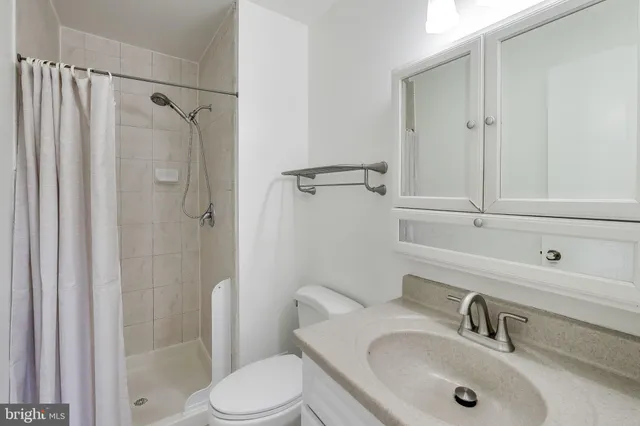 a bathroom with a sink mirror and toilet