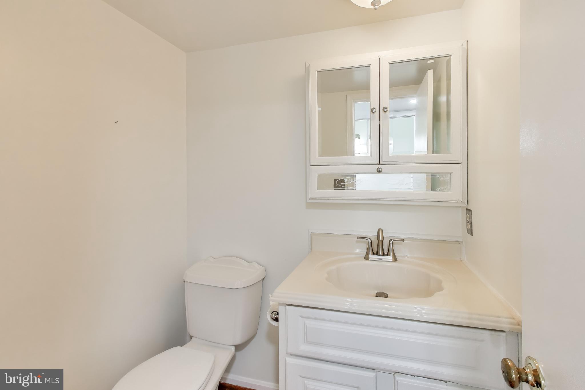 20210 Maple Leaf Court Gaithersburg, MD 20886 - Photo 14 of 31 a bathroom with a sink mirror and toilet
