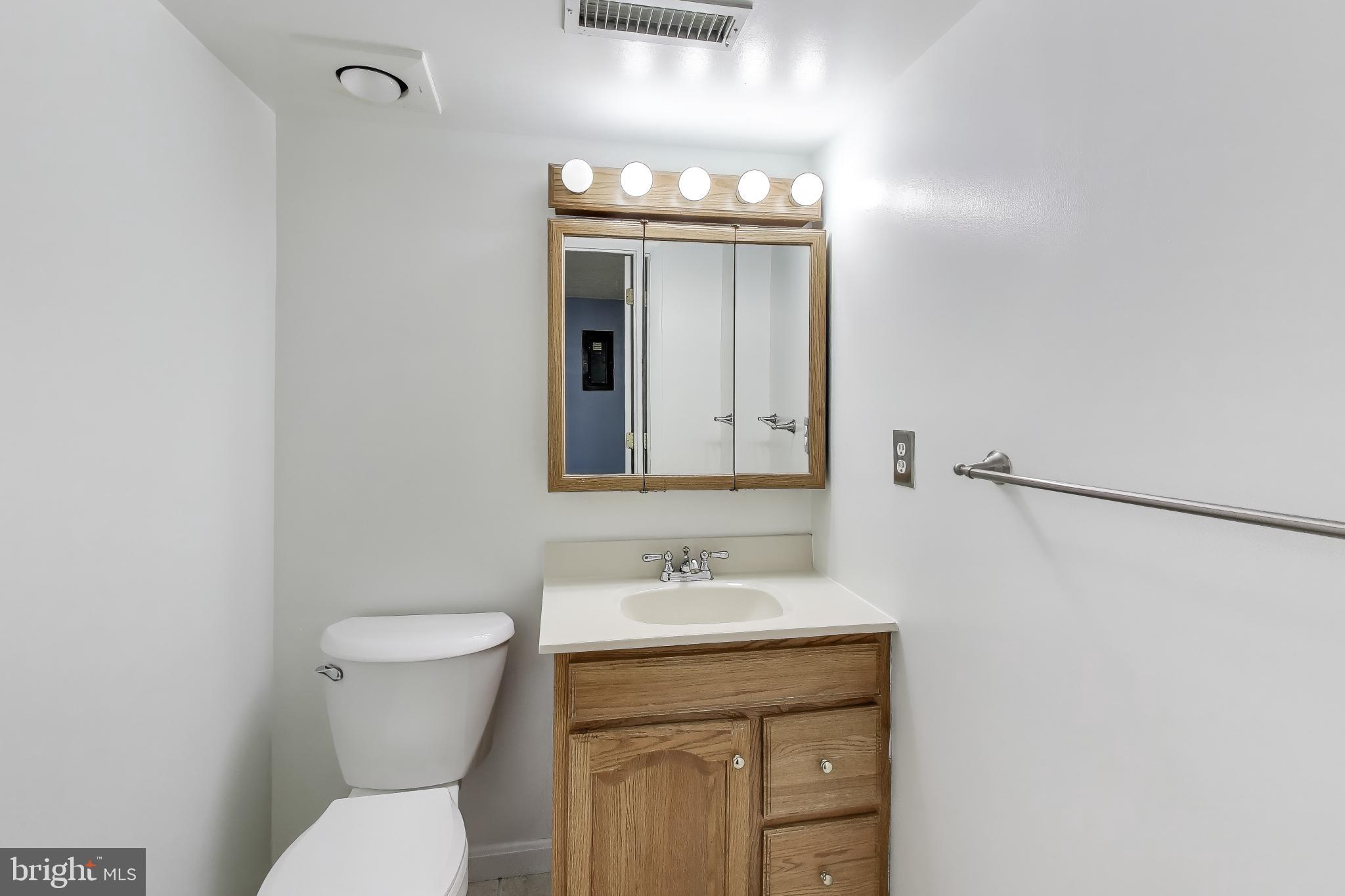 20210 Maple Leaf Court Gaithersburg, MD 20886 - Photo 21 of 31 a bathroom with a toilet sink and mirror