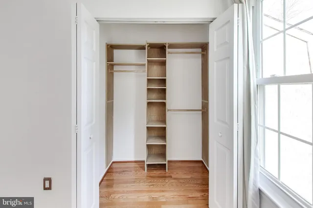 a view of a house with backyard and wooden fence