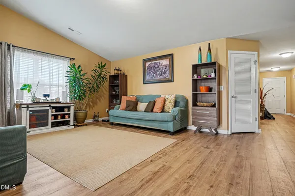 a living room with furniture and wooden floor