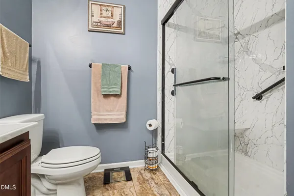 a bathroom with a toilet and a shower