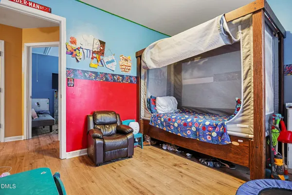 a bedroom with furniture and a baby crib