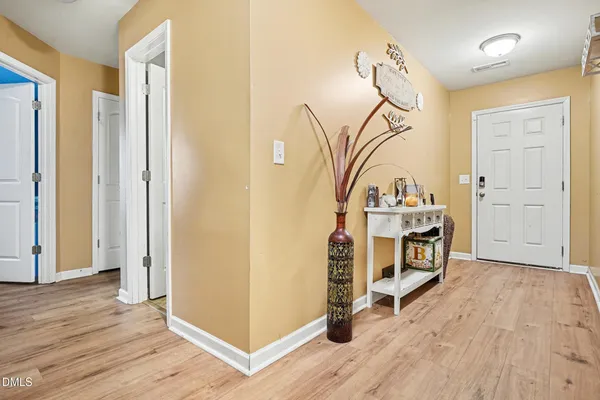 a view of a room with wooden floor and white walls