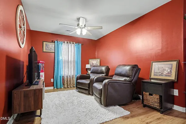 a living room with furniture a ceiling fan and a window