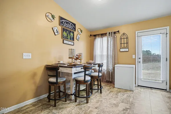 a view of a dining room with furniture and window