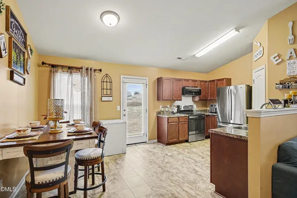 a large kitchen with a table and chairs
