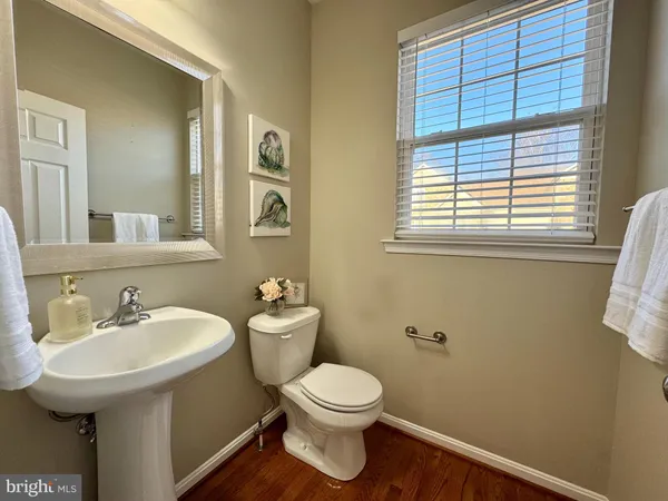 a bathroom with a toilet a sink and a window