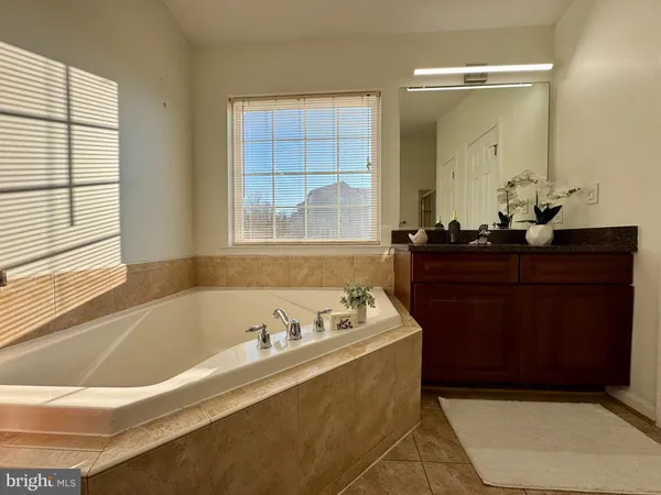 a bath tub sitting in a bathroom next to a window
