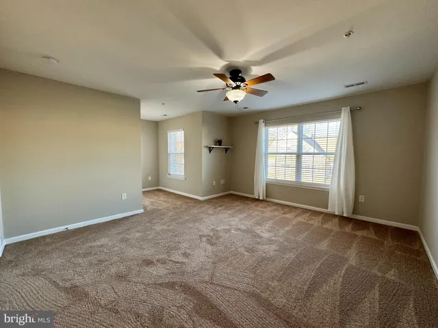 an empty room with a empty space and windows