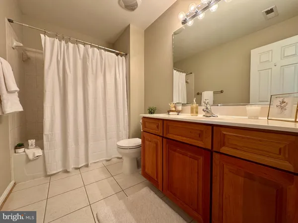 a bathroom with a double vanity sink toilet and a mirror