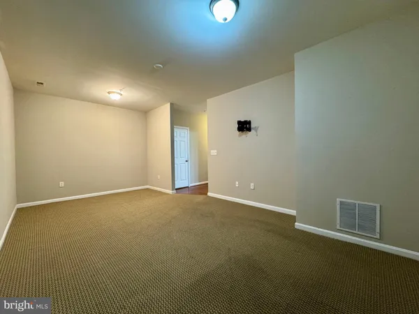 an empty room with a empty space and windows