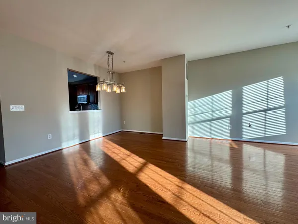 a view of a livingroom with wooden floor and staircase