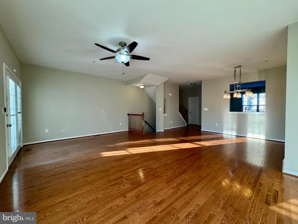 a view of a room with wooden floor and staircase