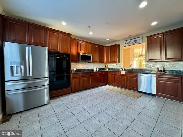 a kitchen with granite countertop stainless steel appliances and cabinets