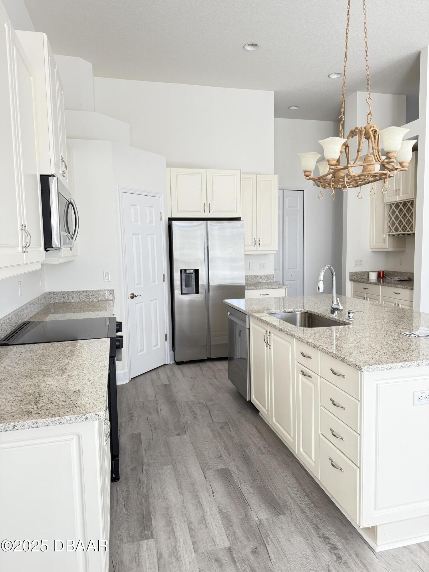 14 Deep Woods Way Ormond Beach, FL 32174 - Photo 21 of 38 a kitchen with stainless steel appliances granite countertop a sink stove and refrigerator