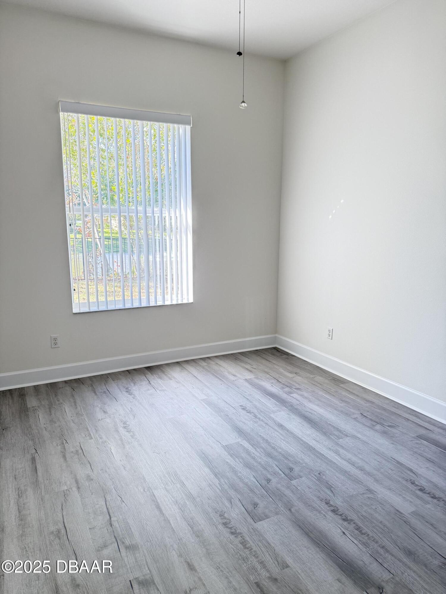 14 Deep Woods Way Ormond Beach, FL 32174 - Photo 24 of 38 an empty room with wooden floor and windows
