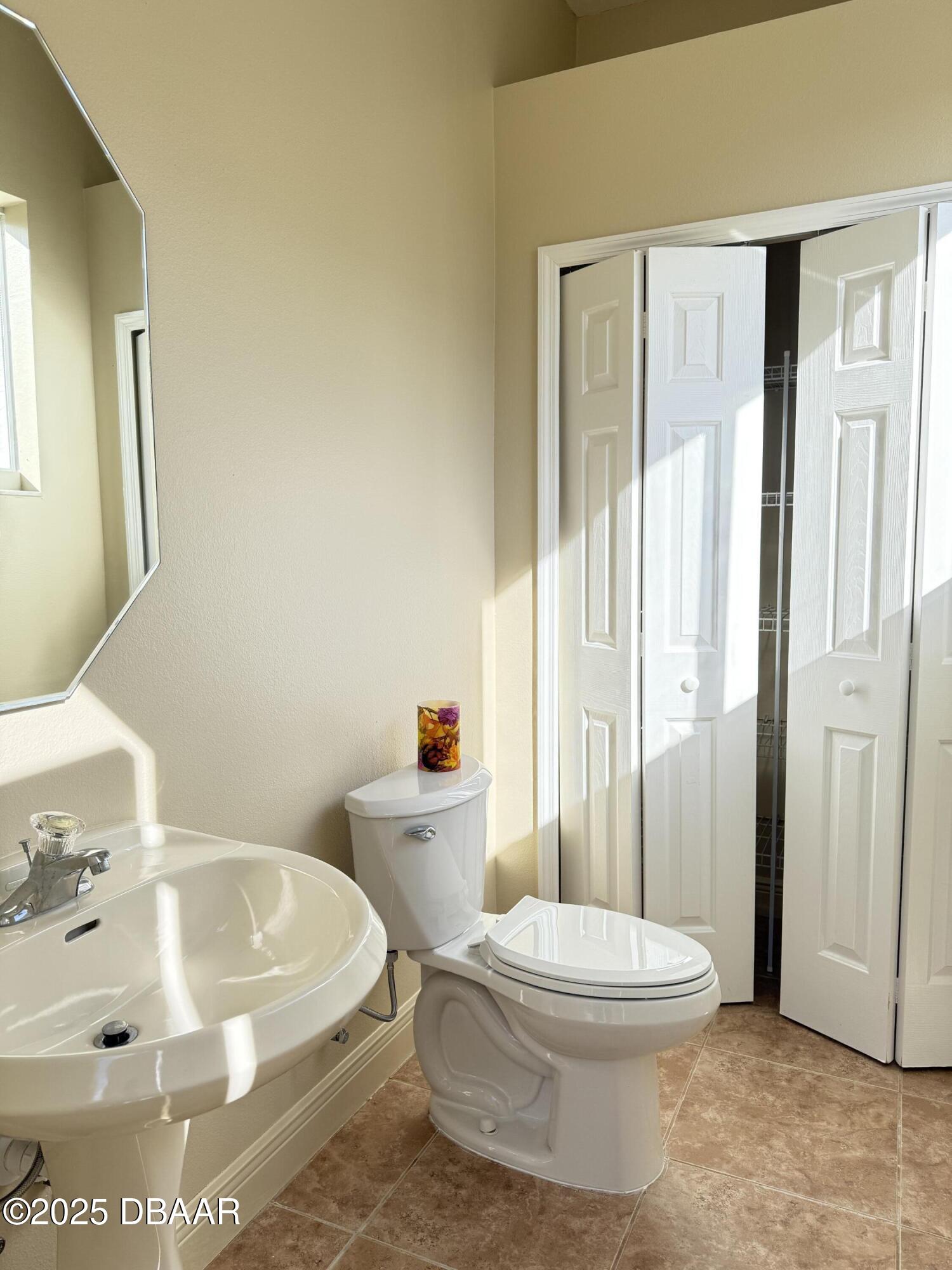 14 Deep Woods Way Ormond Beach, FL 32174 - Photo 32 of 38 a white toilet sitting next to a bathroom sink