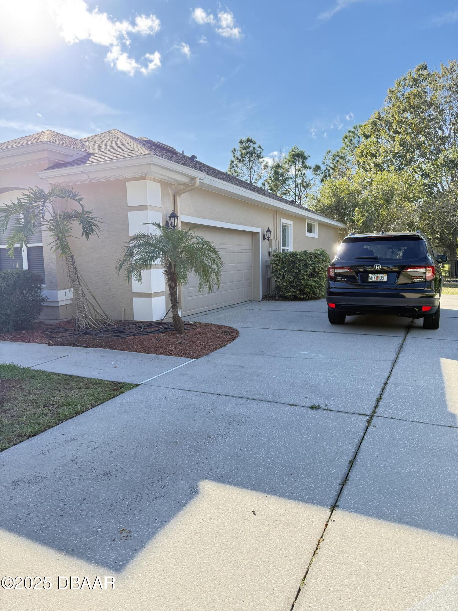 14 Deep Woods Way Ormond Beach, FL 32174 - Photo 37 of 38 a view of a car parked in front of a house