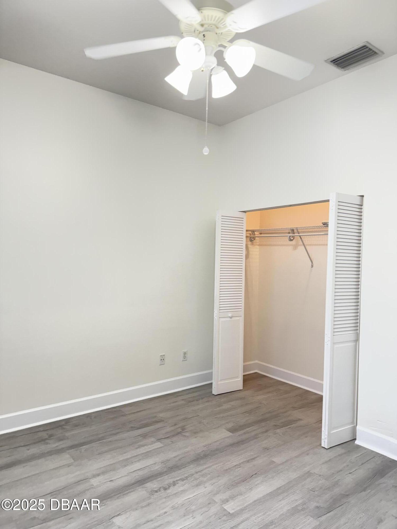 14 Deep Woods Way Ormond Beach, FL 32174 - Photo 8 of 38 an empty room with wooden floor closet and windows